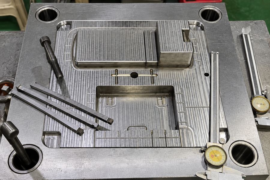 Precision manufacturing mold with calipers and measurement gauges