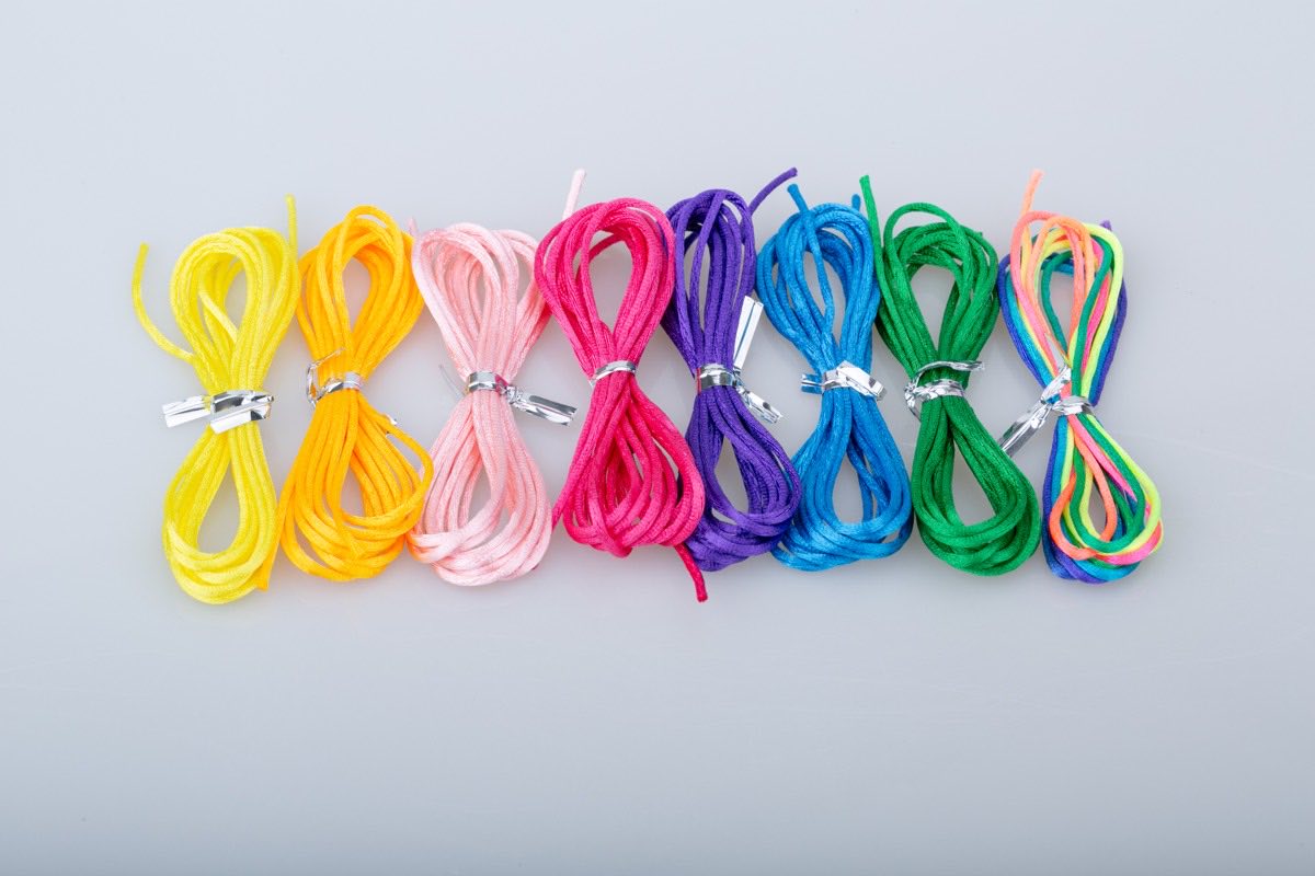 Eight bundles of colored bracelet cord