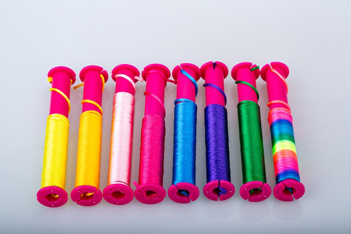 Eight spools of colored bracelet cord